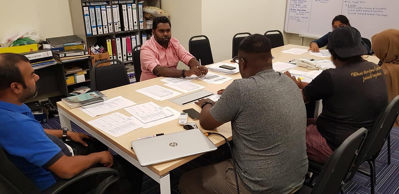 Team reviewing incident investigation paperwork and compliance documents