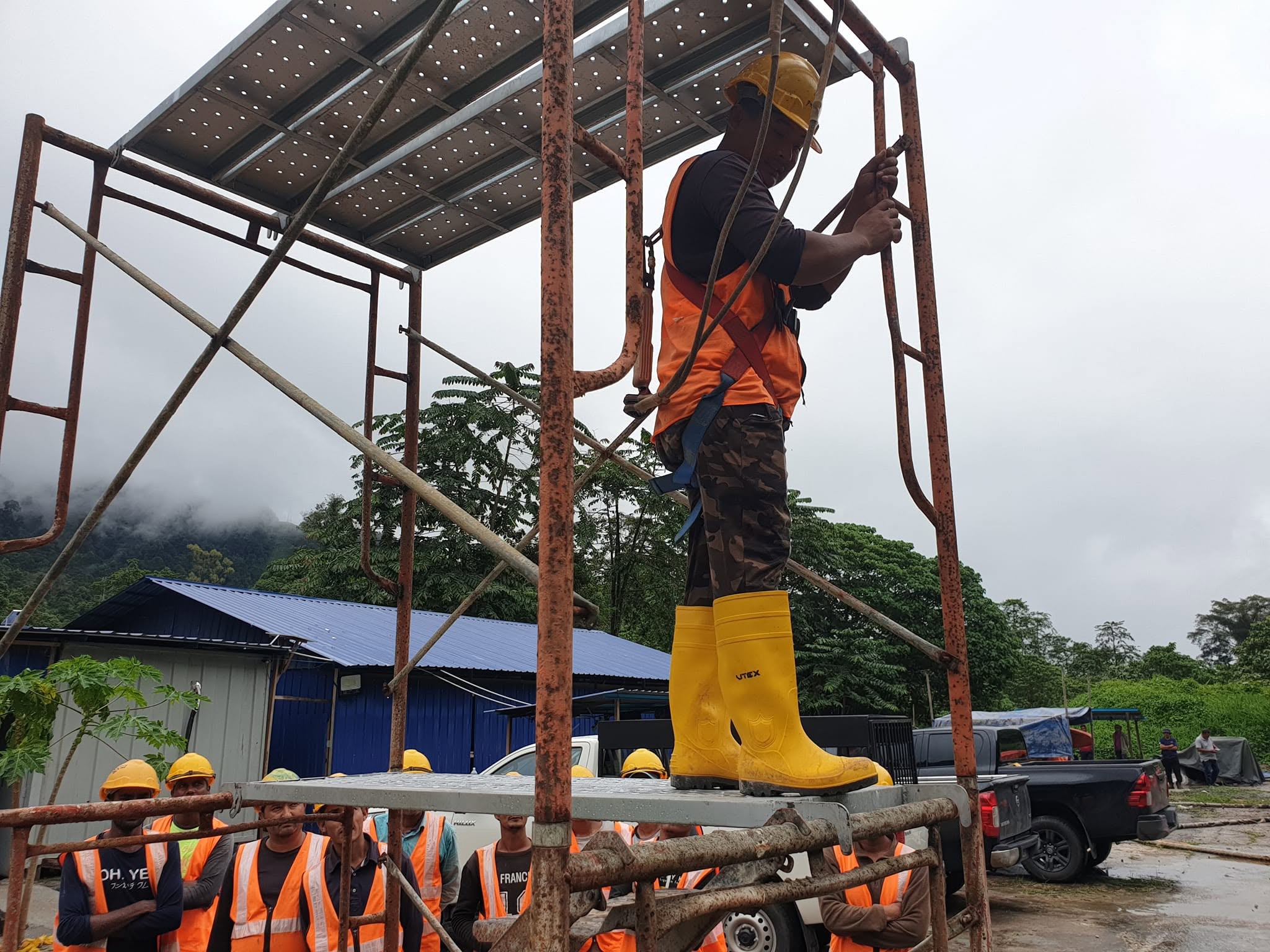 Scaffold safety inspection with crew observing from ground level
