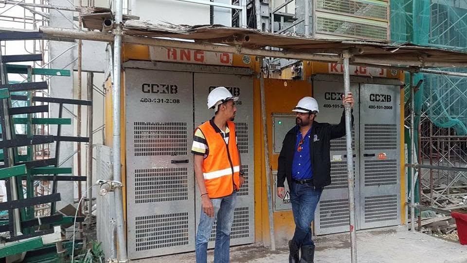 Safety officers discussing hazard assessment near electrical equipment on-site